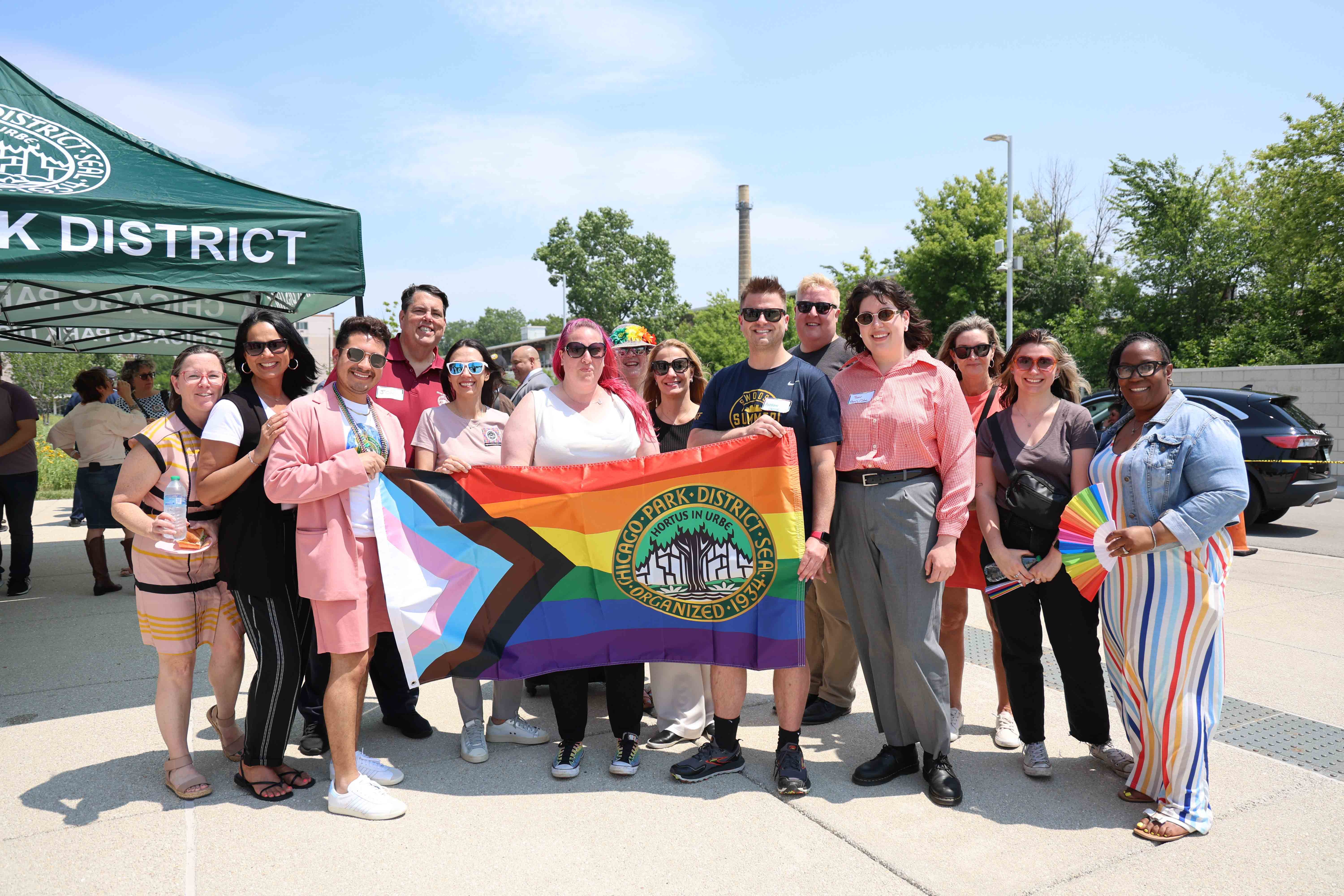 Group photo of Chicago Park District staff holding a Progress Pride flag.